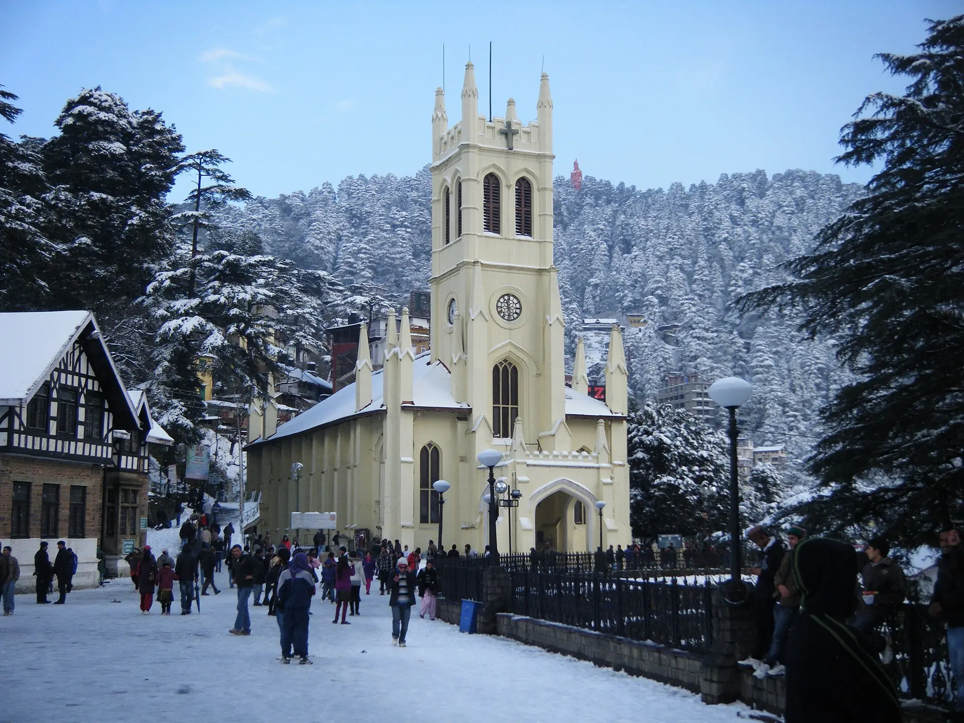 Christ Church on Shimla's Ridge with snow on the ground and people walking past